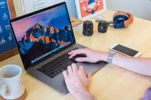 Desk space with someone using a laptop