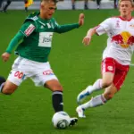 Sports Betting - Football players compete for a ball