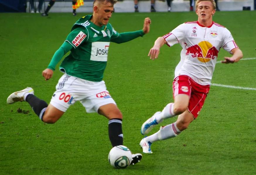 Sports Betting - Football players compete for a ball